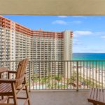 The beautiful interior living area and private balcony view of Condo 1309, a luxury vacation rental at the Shores of Panama resort in Panama City Beach, Florida.