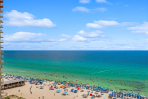 Luxury beachfront condo balcony view looking down at the pool and beach on South Thomas Drive in Panama City Beach