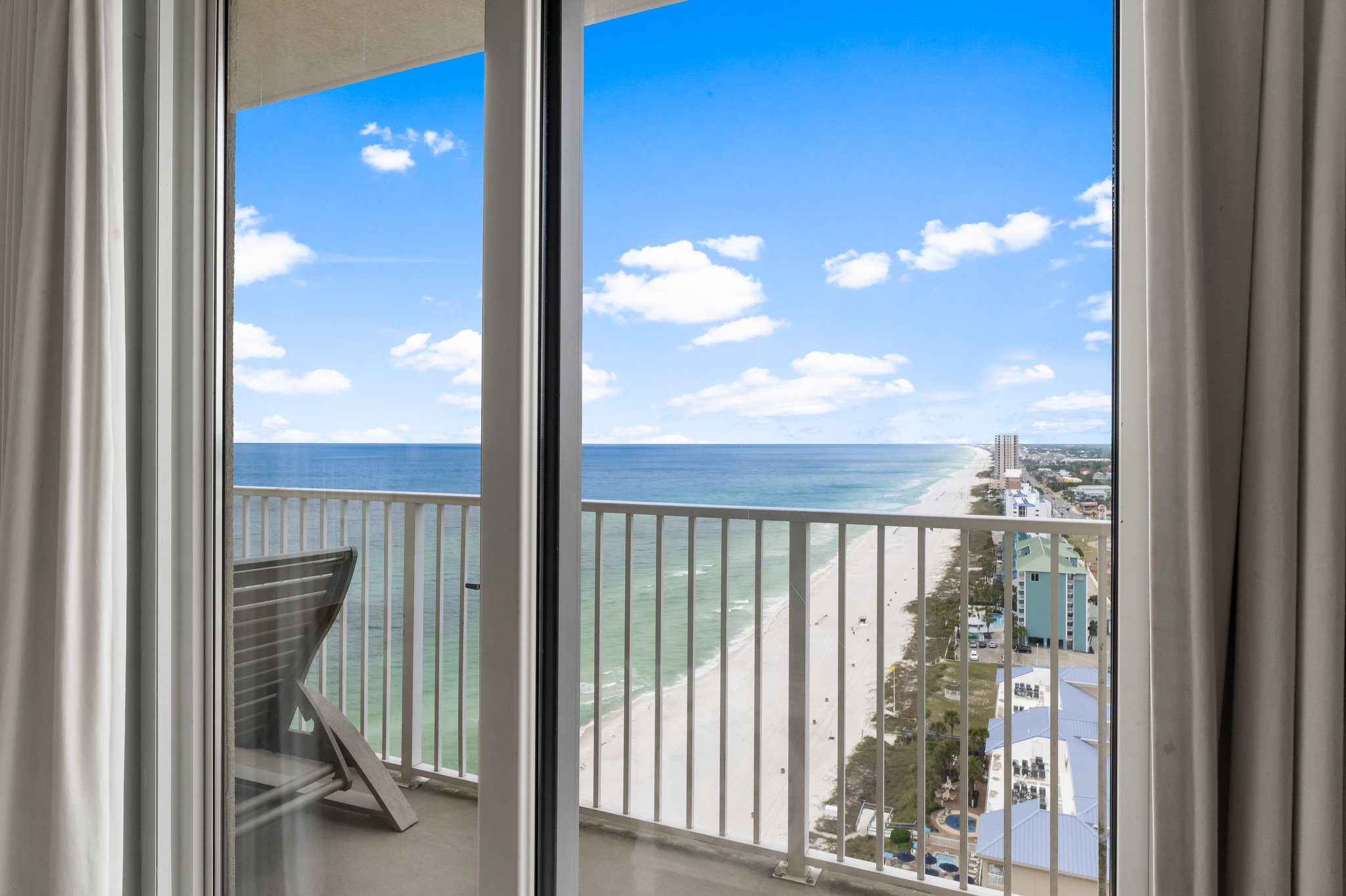 Private beachfront condo balcony overlooking emerald Gulf water and white sand in Panama City Beach