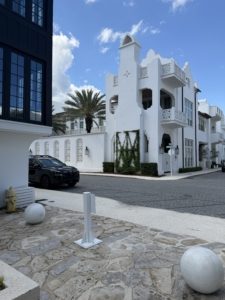 Modern white upscale architecture and beach house rentals surrounded by palm trees in Alys Beach along 30A, Florida.