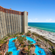 Condo building and pool with beach view