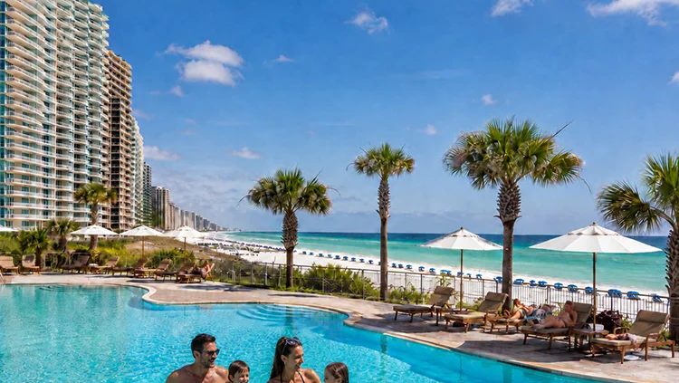 Family enjoying a beachfront condo pool in Panama City Beach