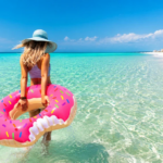 Woman with inflatable float wading into Panama City Beach