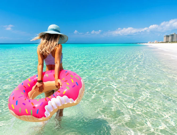 Woman with inflatable float wading into Panama City Beach Woman with inflatable float wading into Panama City Beach